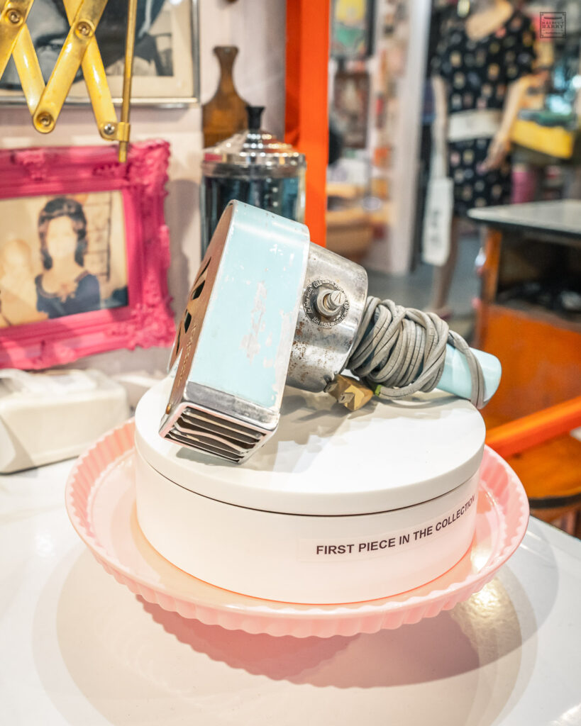 A 1940s Le John hair dryer sits on a spinning pink platform.  This is the first piece in Jeff's collection. 