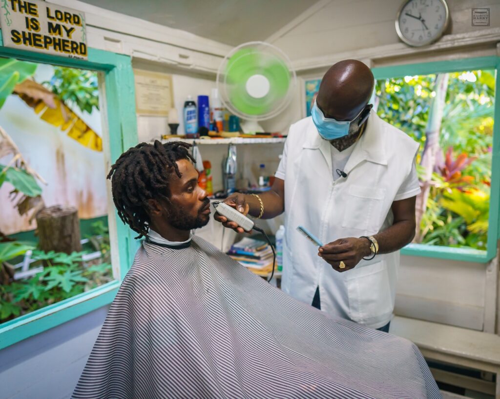 Mr. Paddy working on a customer at Wag's Barbershop in Antigua. 